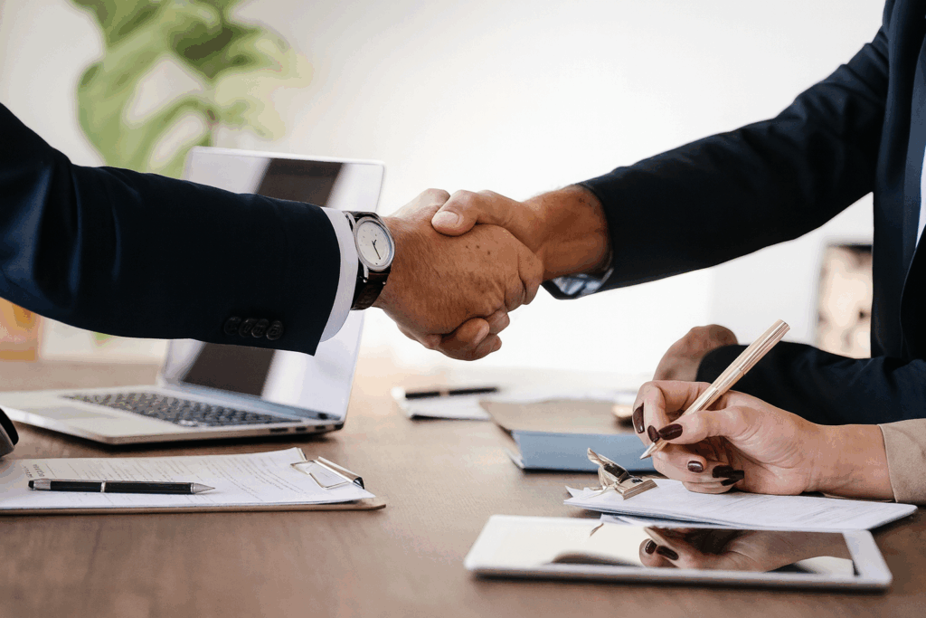 Business agreement during a custom home planning session — Custom Home Builders in Alberta