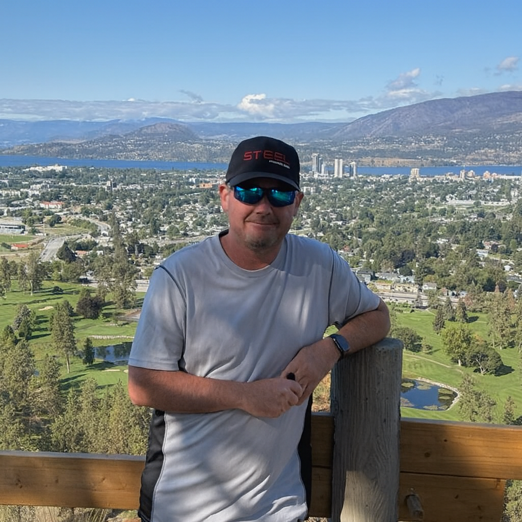 Builder wearing STEEL Structure Homes cap standing in front of panoramic view — Custom Home Builders in Ontario